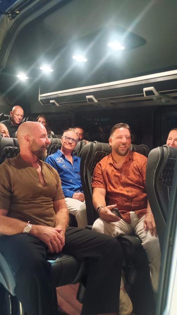 Travelers smiling inside a private Cabo shuttle late at night returning from dinner